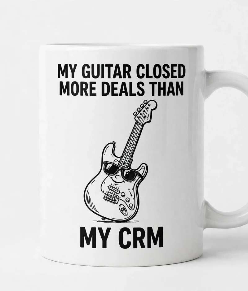 Guitar Closes Deals mug — white ceramic mug with a cartoon guitar in sunglasses