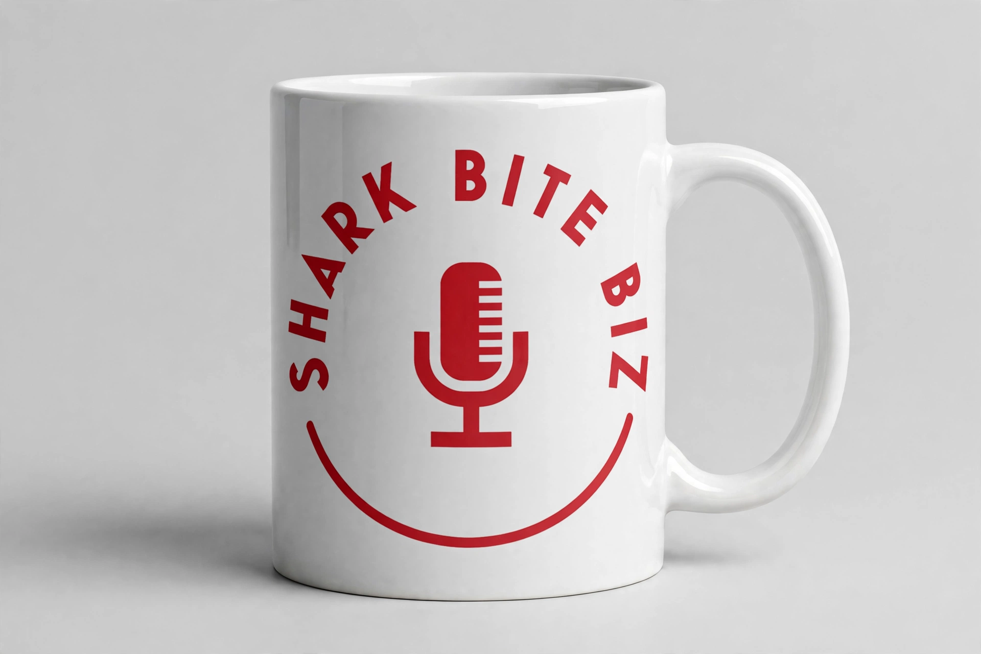 Shark Bite Biz coffee mug — white ceramic mug with the official Shark Bite Biz logo in red