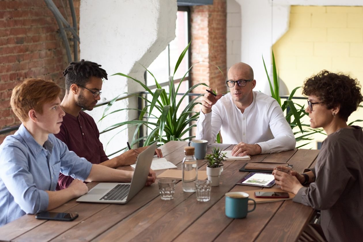Business team around a table working through an ERP recovery plan