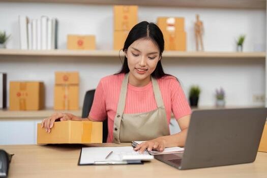 Small business owner packing orders at her desk