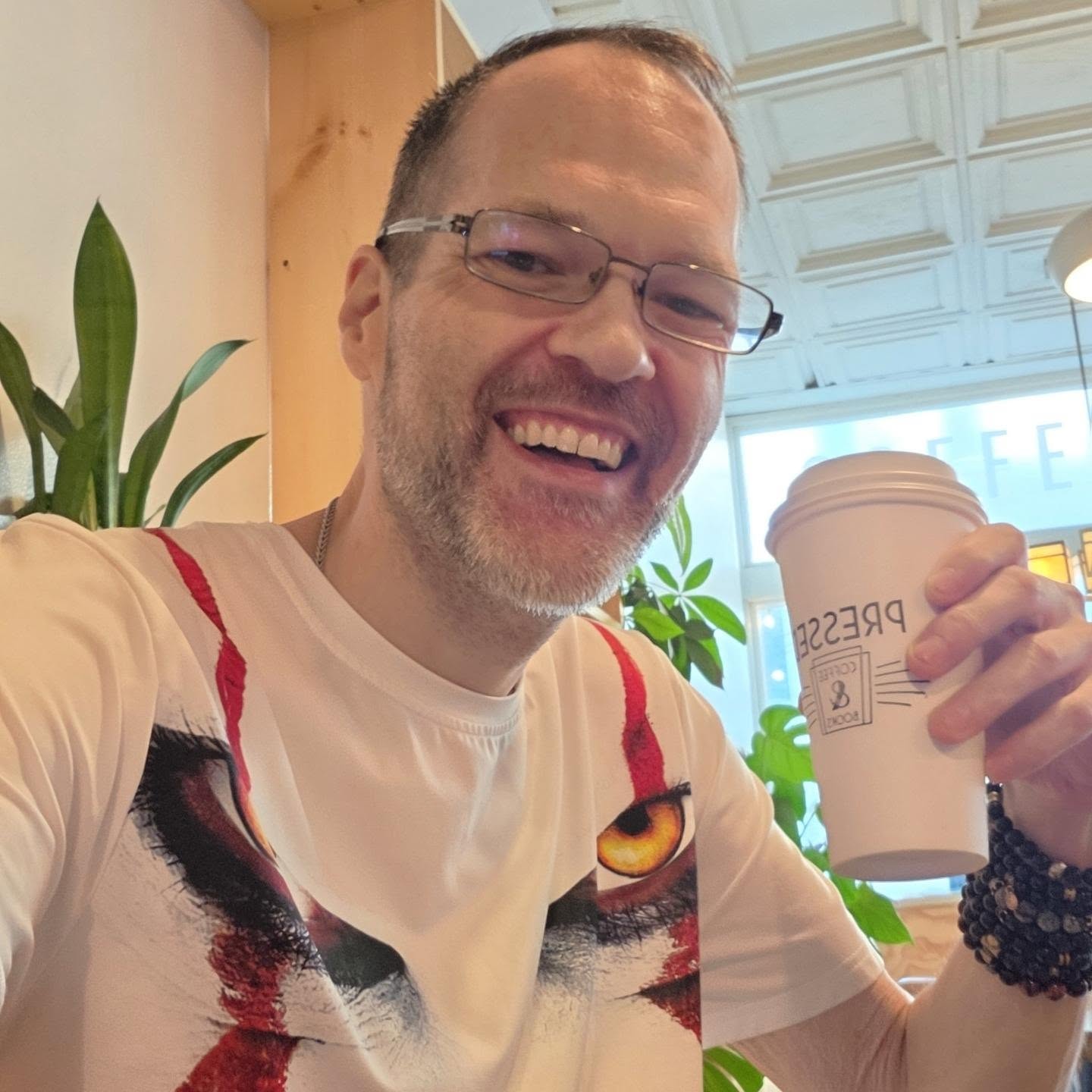 David Strausser holding a coffee cup