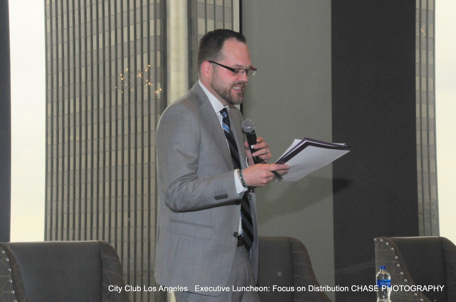 David Strausser speaking on stage at City Club Los Angeles